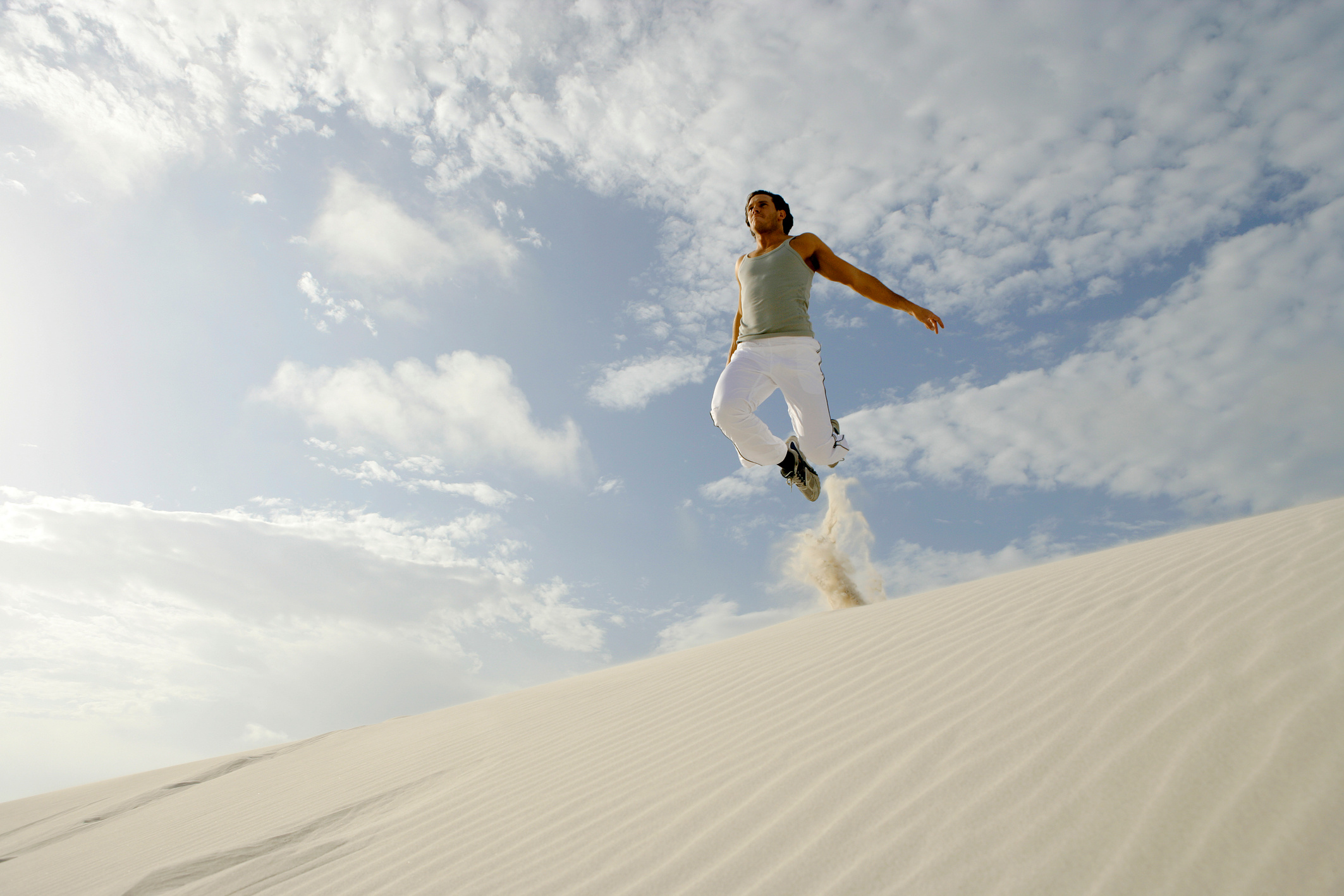 Man jumping in sand